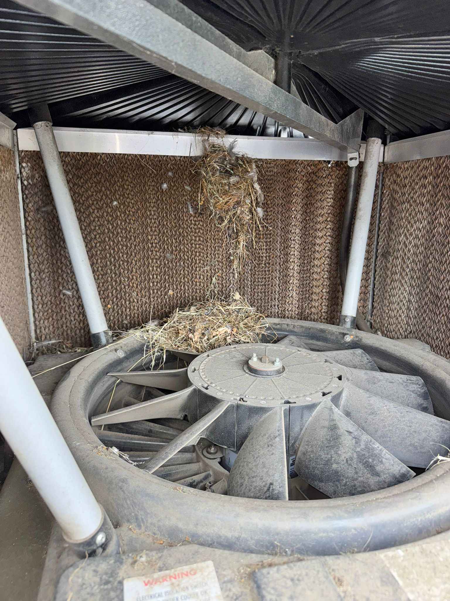 A FreshDuct technician servicing a roof-mounted evaporative cooler on a period Melbourne home