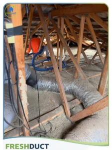 Vacuuming attic old blow in insulation and preparing for new insulation