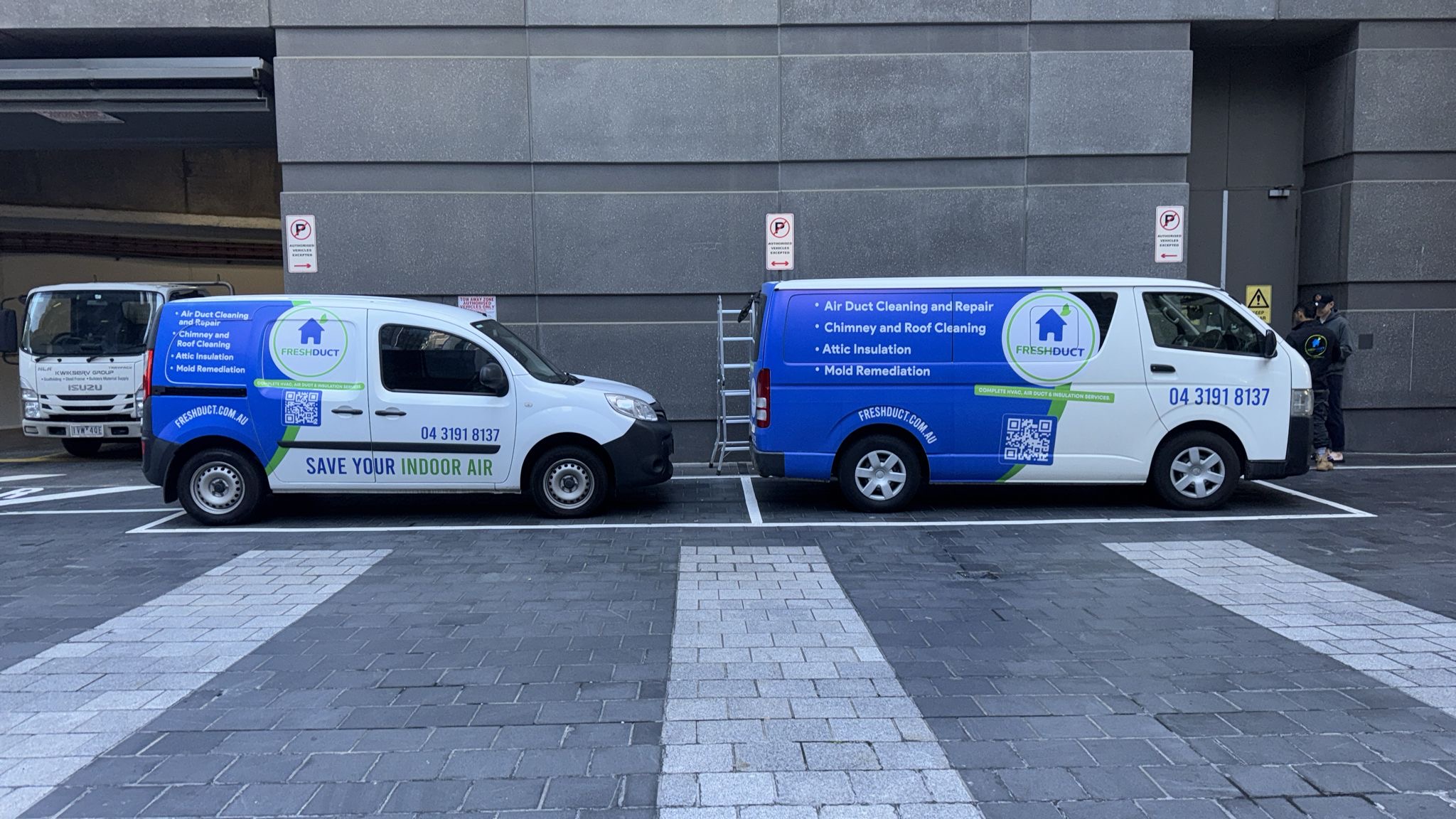 Two FreshDuct branded vans parked at Melbourne apartment job