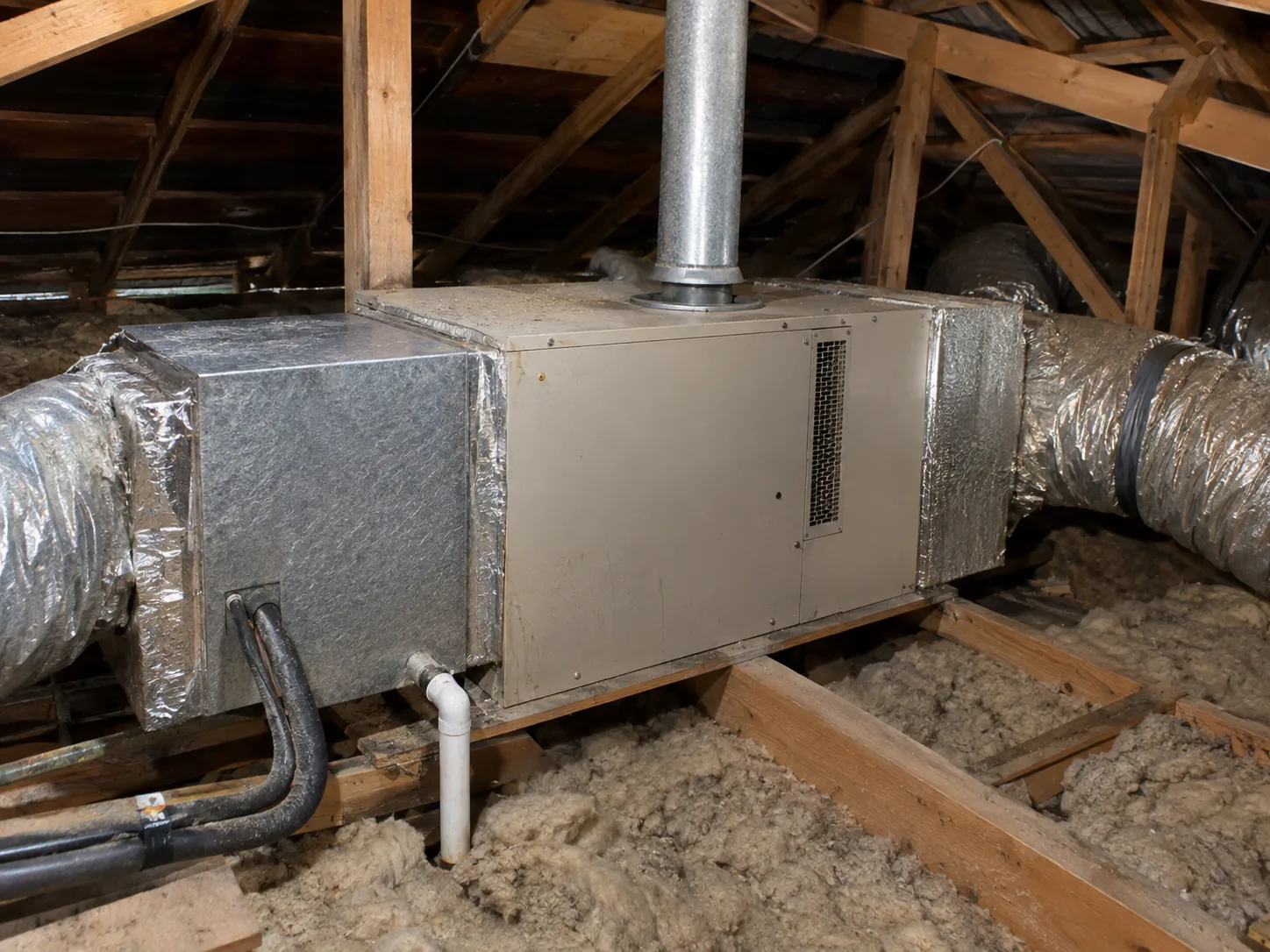 A gas ducted heater in the roof space with the add-on cooling coil section and refrigerant lines running to it