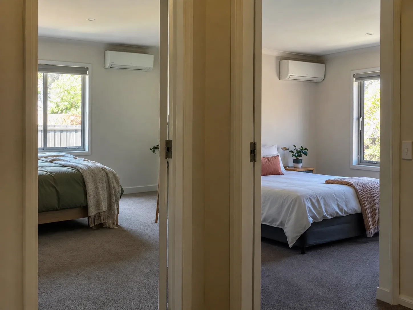 Two bedrooms off one hallway, each with its own wall unit