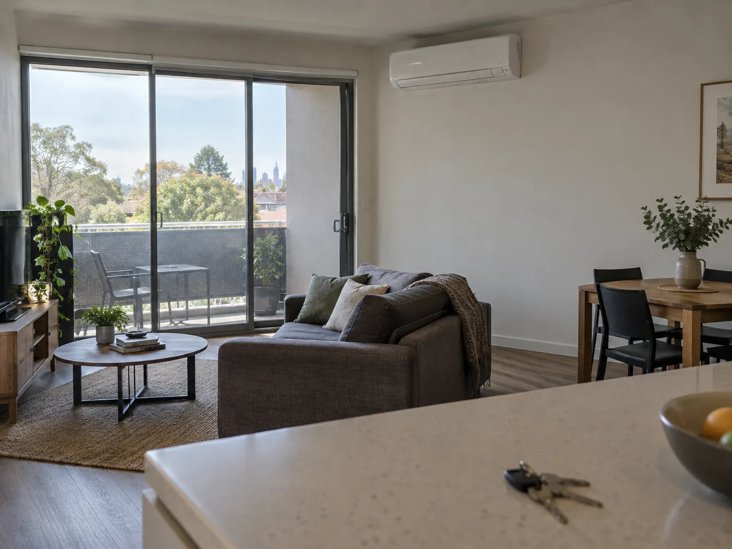 A rental apartment living room with a new wall split above the balcony door