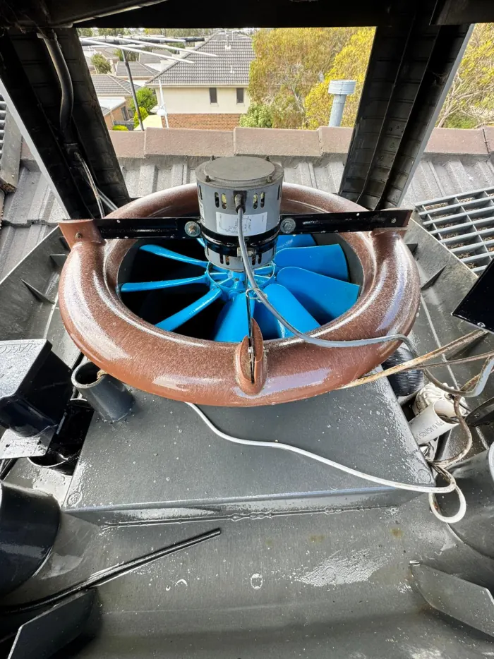 The same evaporative cooler after a FreshDuct service, clean housing and clear fan blades