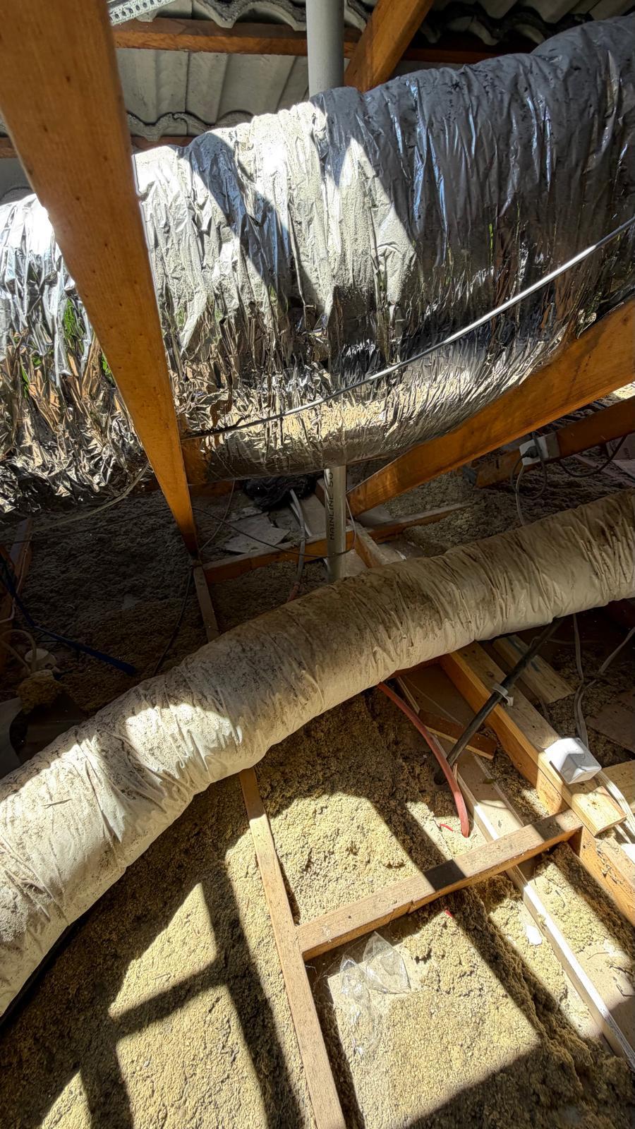 Old settled blow-in insulation in Glen Waverley roof space before removal